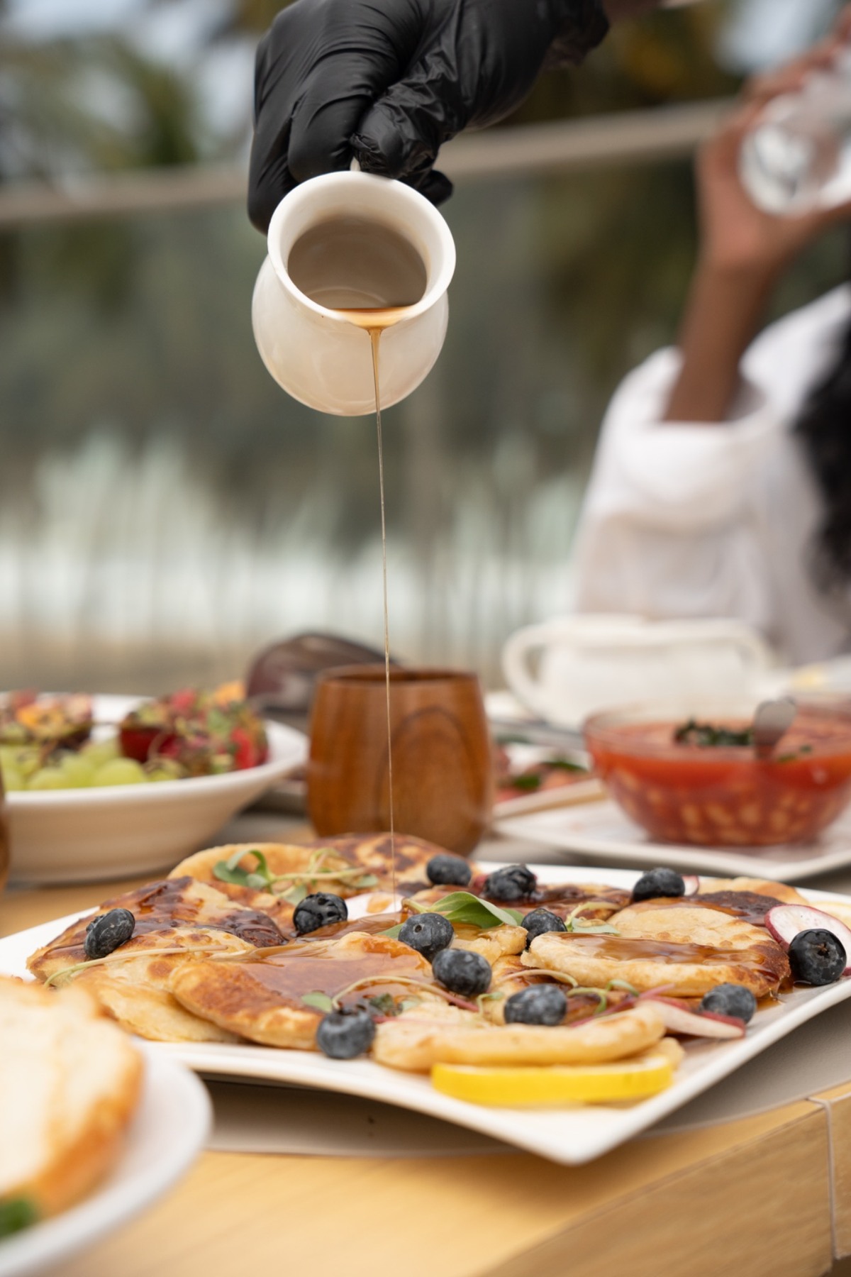 Syrup poured over a freshly prepared breakfast